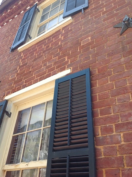storm shutters and brick